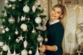 Beautiful, young woman decorating a Christmas tree Royalty Free Stock Photo