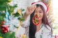 Beautiful young woman decorating xmas ornament on Christmas tree for Christmas and New Year holiday Royalty Free Stock Photo