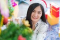 Beautiful young woman decorating xmas ornament on Christmas tree for Christmas and New Year holiday Royalty Free Stock Photo