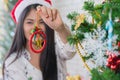 Beautiful young woman decorating xmas ornament on Christmas tree for Christmas and New Year holiday Royalty Free Stock Photo