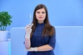 Beautiful young woman doctor with syringe in her hand, female nurse looks in camera Royalty Free Stock Photo