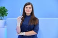 Beautiful young woman doctor with syringe in her hand, female nurse looks in camera Royalty Free Stock Photo