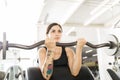 Woman Doing Biceps Curl With Barbell In Fitness Club Royalty Free Stock Photo