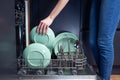 Beautiful young woman doing dishes in the kitchen Royalty Free Stock Photo