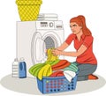 Beautiful young woman doing laundry at home.