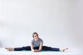 Beautiful young woman doing stretching exercises of gray wall Royalty Free Stock Photo