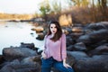 Beautiful young woman. Dramatic outdoor portrait of sensual brunette female with long hair. Sad and serious girl.