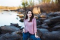 Beautiful young woman. Dramatic outdoor portrait of sensual brunette female with long hair. Sad and serious girl.