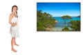 Beautiful young woman dreaming of the next vacation in front of a photo of an idyllic beach Royalty Free Stock Photo