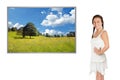 Beautiful young woman dreaming of the next vacation in front of a photo of an idyllic landscape Royalty Free Stock Photo