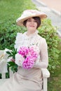 Beautiful young woman in dress and hat portrait in retro style. Vogue dressing in vintage Royalty Free Stock Photo