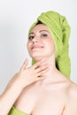 Beautiful Young woman dressed in a bath towel makes a cosmetic mask on the face. beauty industry and home skin care Royalty Free Stock Photo