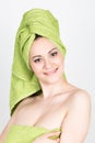 Beautiful Young woman dressed in a bath towel makes a cosmetic mask on the face. beauty industry and home skin care Royalty Free Stock Photo