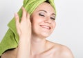 Beautiful Young woman dressed in a bath towel makes a cosmetic mask on the face. beauty industry and home skin care Royalty Free Stock Photo