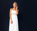 Beautiful young woman dressed in white evening gown. Portrait of beautiful young woman dressed in white evening gown Royalty Free Stock Photo