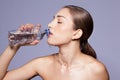 Beautiful young woman drinking from a bottle of water Royalty Free Stock Photo