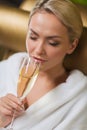 Beautiful young woman drinking champagne at spa Royalty Free Stock Photo