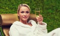 Beautiful young woman drinking champagne at spa Royalty Free Stock Photo