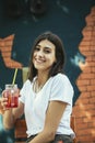 Young woman drinking cocktail in outdoor cafe Royalty Free Stock Photo