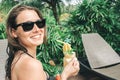 Beautiful young woman drinking cocktail while relaxing in sunbed Royalty Free Stock Photo