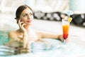 Beautiful young woman drinking a cocktail while in the swimming Royalty Free Stock Photo