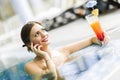 Beautiful young woman drinking a cocktail while in the swimming Royalty Free Stock Photo