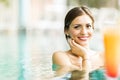 Beautiful young woman drinking a cocktail while in the swimming Royalty Free Stock Photo