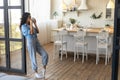 Beautiful young woman drinking coffee from cup, relaxing with hot drink at home, empty space Royalty Free Stock Photo