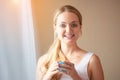 Beautiful young woman drinking coffee in the morning. Charming beautiful young woman hands holding hot cup of coffee or tea Royalty Free Stock Photo