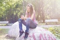 Beautiful young woman drinking coffee in a morning park Royalty Free Stock Photo