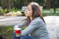 Beautiful young woman drinking coffee in a morning park Royalty Free Stock Photo