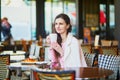 Woman drinking coffee in outdoor cafe or restaurant, Paris, France Royalty Free Stock Photo