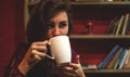 Beautiful Young Woman Drinking Coffee or Tea. Beauty Model Girl enjoying beverage. Lady holding Cup of coffee or tea Royalty Free Stock Photo