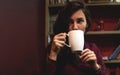 Beautiful Young Woman Drinking Coffee or Tea. Girl Start drinking decaffeinated drinks and enjoying this beverage. Lady Royalty Free Stock Photo