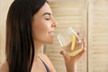 Beautiful young woman drinking fresh lemon water Royalty Free Stock Photo