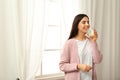 Beautiful young woman drinking fresh lemon water. Space for text Royalty Free Stock Photo