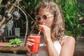 Beautiful young woman drinking fruit cocktail on a tropical beach Royalty Free Stock Photo