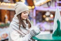 Beautiful young woman drinking hot coffee on the street. Concept Lifestyle, Urban, Winter, Vacation, Happy Christmas, New Year Royalty Free Stock Photo