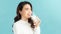 Beautiful young woman drinking milk on blue background Royalty Free Stock Photo