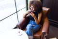 Beautiful young woman drinking red tea in a coffee shop. Royalty Free Stock Photo