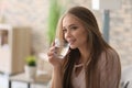 Beautiful young woman drinking water at home Royalty Free Stock Photo