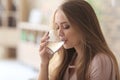 Beautiful young woman drinking water at home Royalty Free Stock Photo