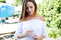 Beautiful young woman drinking water in the home garden. Royalty Free Stock Photo