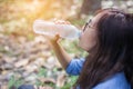 Beautiful young woman drinking water in the morning after finished jogging Royalty Free Stock Photo