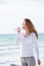 Beautiful young woman drinking water in summer Royalty Free Stock Photo