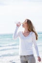 Beautiful young woman drinking water in summer Royalty Free Stock Photo