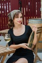 Beautiful young woman drinking white wine on the terrace of a restaurant. Royalty Free Stock Photo