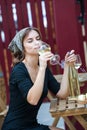 Beautiful young woman drinking white wine on the terrace of a restaurant. Relaxing after work with a glass of wine Royalty Free Stock Photo