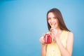 Beautiful young woman drinks strawberry smoothie on blue background. Healthy organic drinks concept. People on a diet. Royalty Free Stock Photo