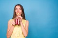 Beautiful young woman drinks strawberry smoothie on blue background. Healthy organic drinks concept. People on a diet. Royalty Free Stock Photo